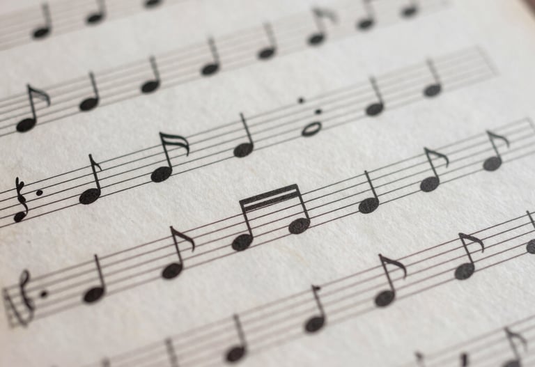 Abstract composition of musical notes on a sheet, dusty rose and antique white colors, soft focus, professional music photography.