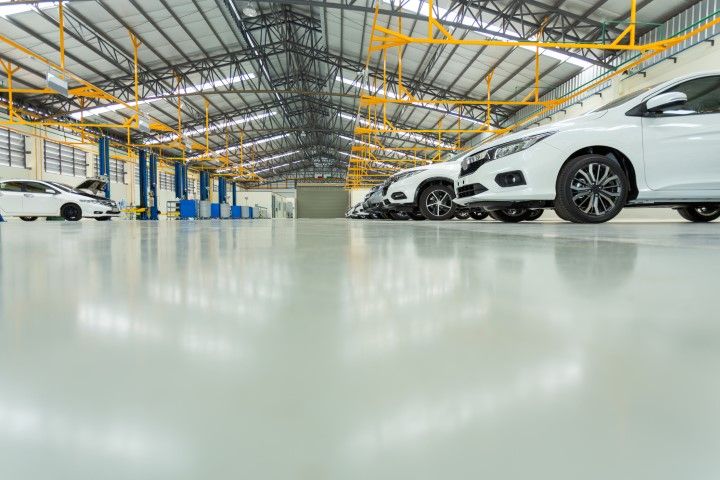 a car parked in an epoxy flooring showroom