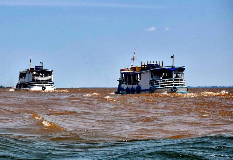two boats are in the water near the shore