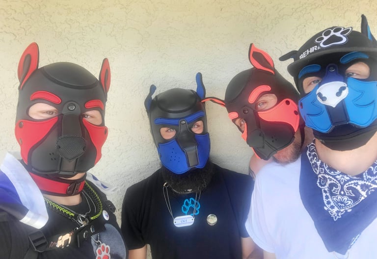 Four men. posing in pup masks.