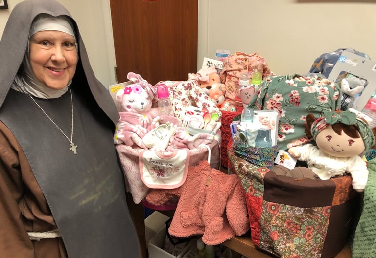 A fransican Daughter of Mary making baby baskets at the Rose Garden Mission