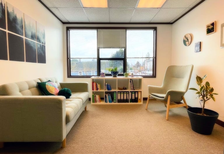 a well lit room with a couch and a chair