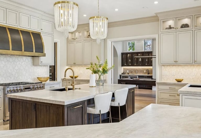 Kitchen remodel with an island, seating, pendant lighting, and surrounding cabinetry.