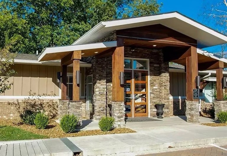 a man standing in front of a building with a dog