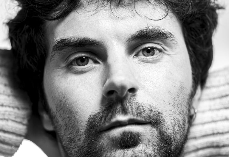 a man with a beard and a sweater on