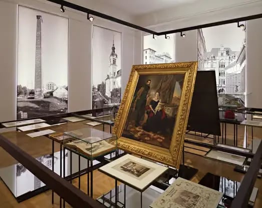 Historic Graz Museum interior with golden-framed painting and archival display cases
