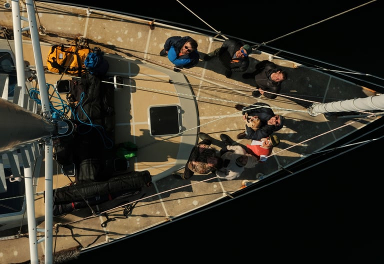 a group of people standing on a sailing boat in Tromsø | ski and sail in Norway