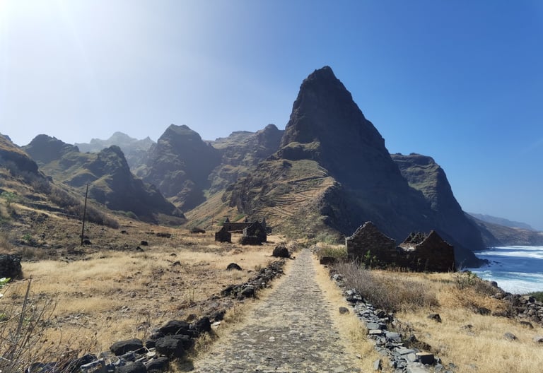Stone path leading past mountain ruins along the scenic coast of Santo Antao, Cape Verde.