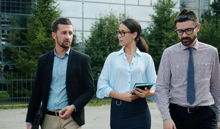 Corporate professionals discussing business expansion and sales execution strategies outdoors