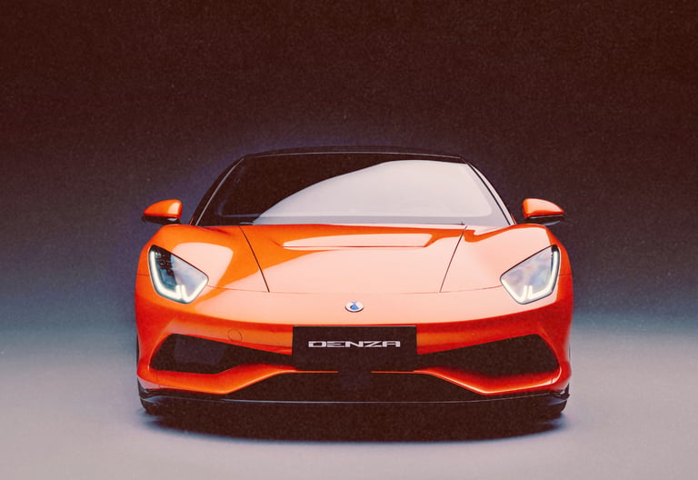 Front view of a sleek orange Denza electric sports car with LED headlights against a dark background.