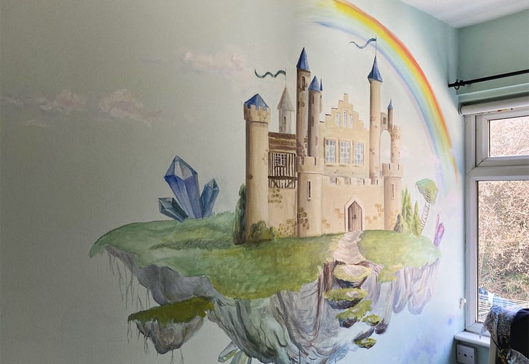 Kid's mural of a magical castle with crystals, a rainbow and white clouds