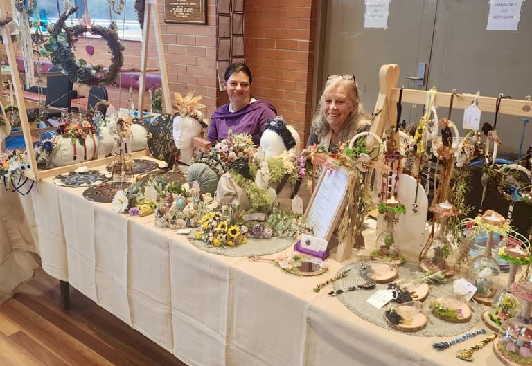 a market stall table selling handmade headwear, suncatchers & spiritual products