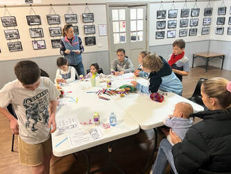 Kid's sitting around tables, engaged in activities