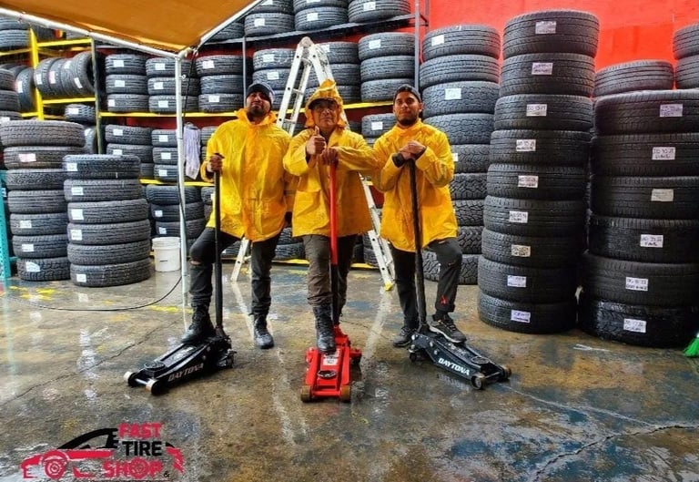 Fast Tire Shop mechanics team taking a break at the East Los Angeles workshop under a Michelin and G
