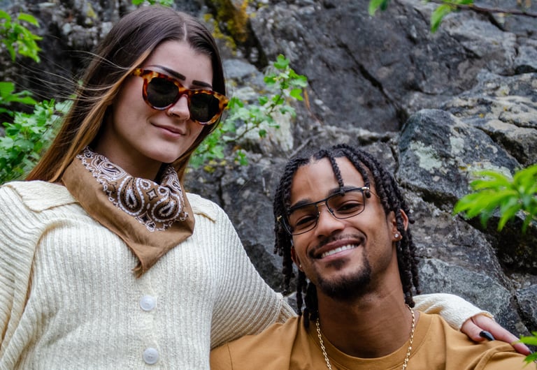 Man and woman in nature wearing eco-conscious fashion eyewear