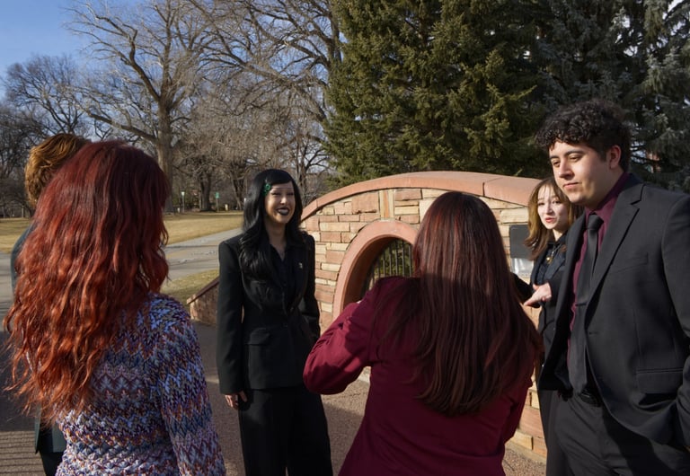 Image of the Quesada-Stoner Gregg teams standing in a circle. All looking at Quesada-Stoner.
