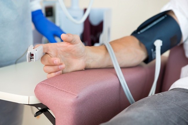 a person with a blood pressure monitor on their arm