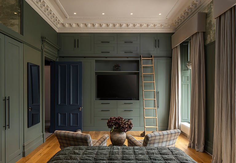 a bedroom with a ladder to climb up to the bed