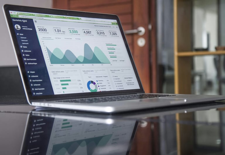 A computer showing different analytics and graphs on the screen