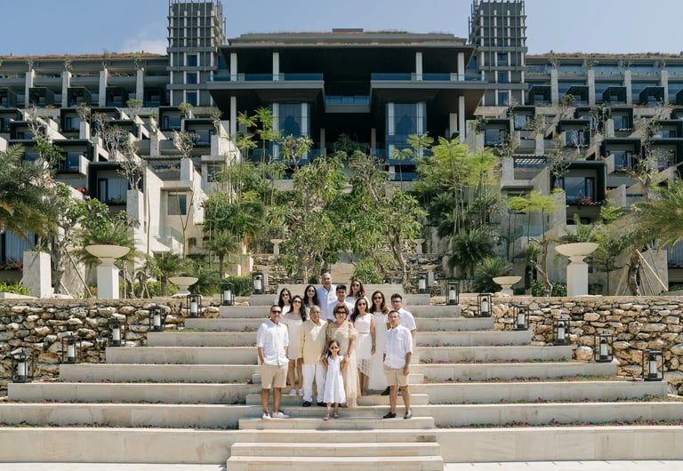 Multi-generation family portrait on the iconic Grand Staircase at The Apurva Kempinski Bali in Nusa Dua