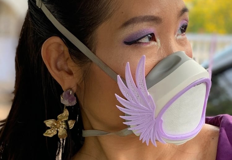 flo-1: Female face with Flomask and Wings Up decoration