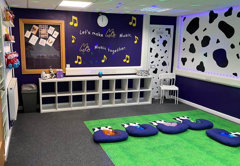 The moo room with the seat set up for class, walls to show the moo slogan, gift shop and cow print.