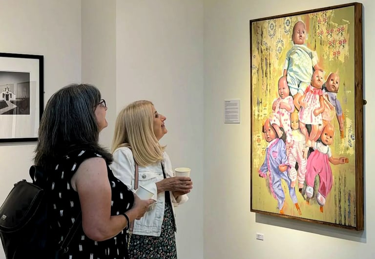 Visitors looking at my painting 'Playthings' at an AA2A Exhibition in Chester. 