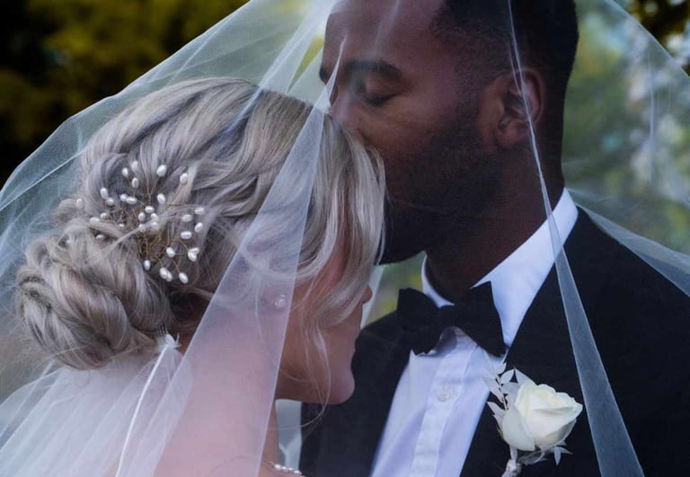 a bride and groom kissing on their wedding day