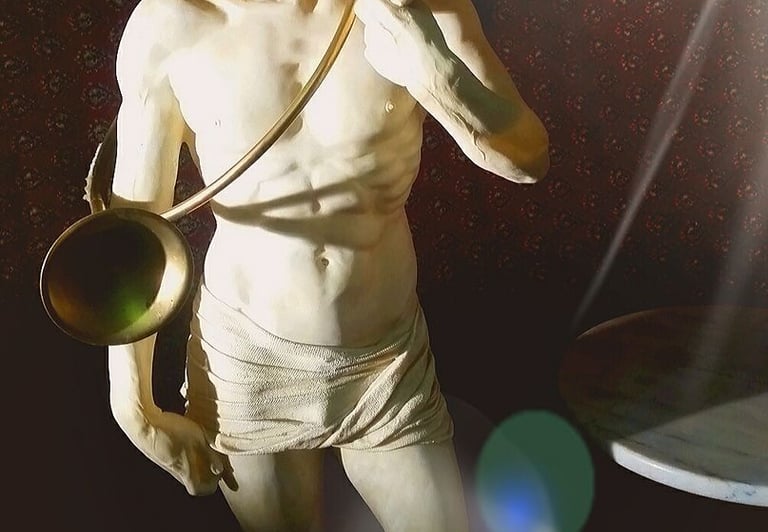 a statue of a man with a lamp on a table