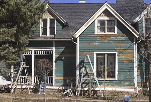 before image of house exterior before being painted. red deer