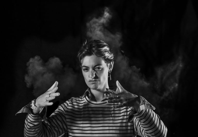 a man in striped shirt holding a cigarette