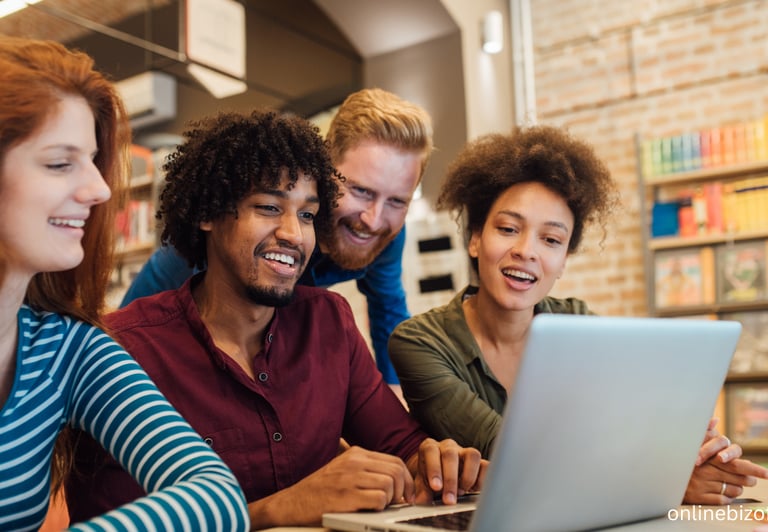a group of people sitting around a laptop computer
