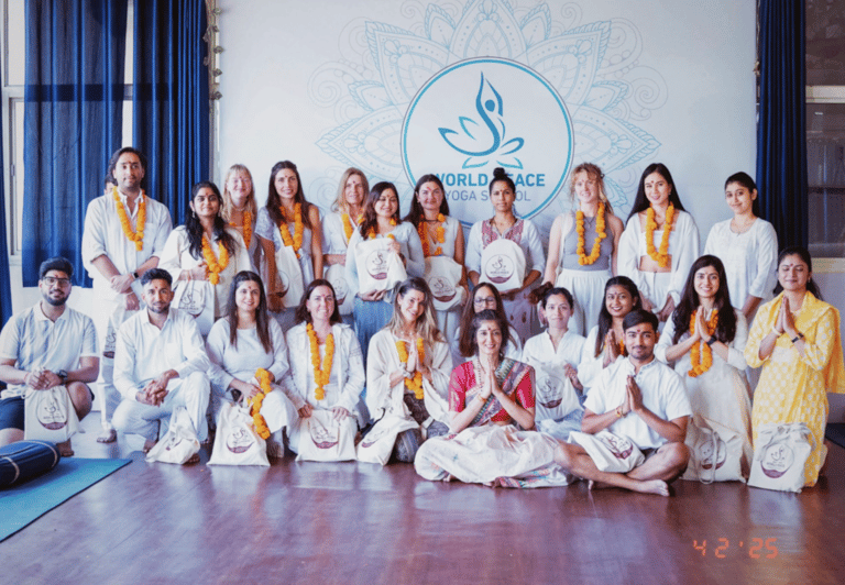 A group picture of people who have been certified as yoga instructors.