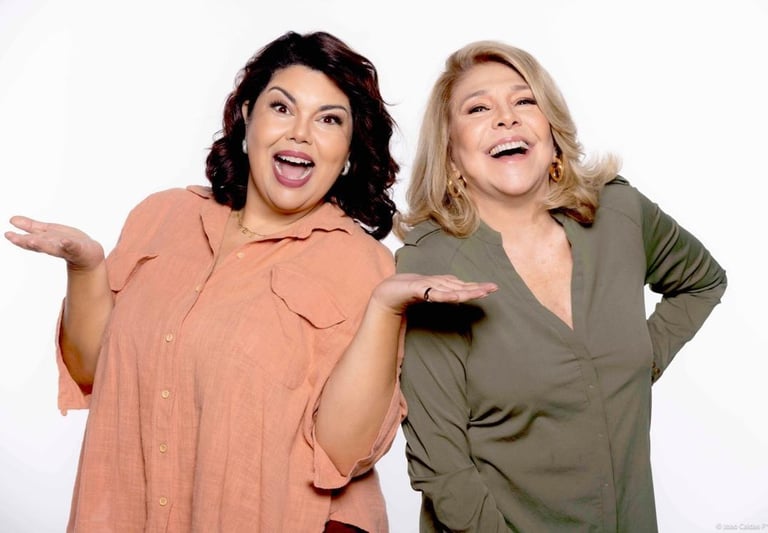 two women standing next to each other holding hands