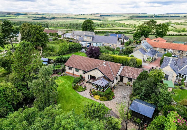 a house with a large garden and a large lawn