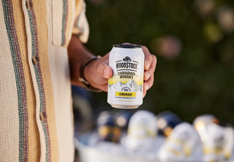 Product campaign photography - a man holding a woodstock can