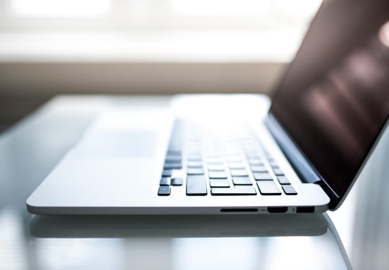 a laptop computer sitting on a table with a laptop