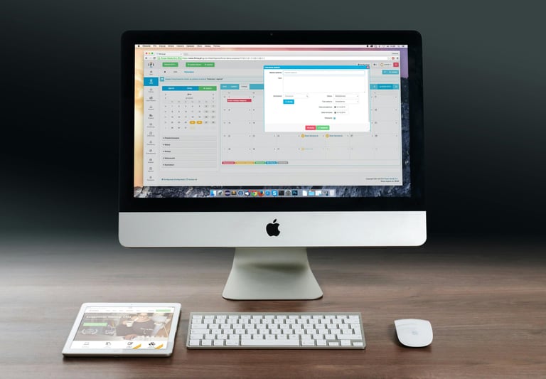 a computer monitor and a keyboard on a desk