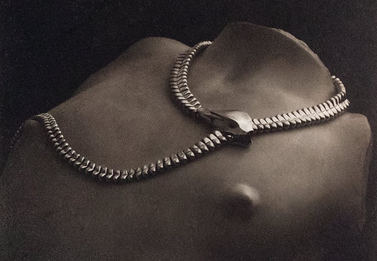 Platinum and silver art photo of a a snake necklace by Tiffany & Co on a woman's torso in marble