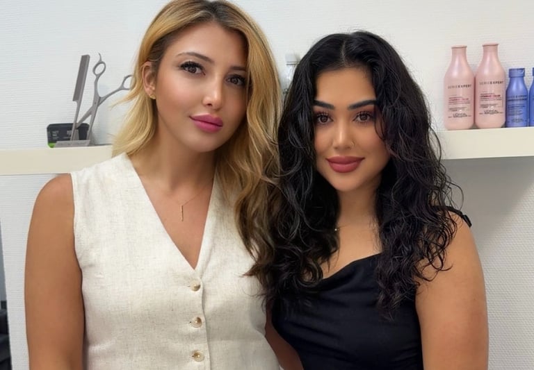 two women standing next to each other in a room