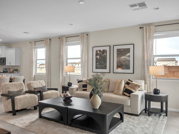 a living room with a couch and chairs