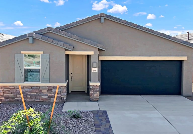 a house with a garage door and a garage door