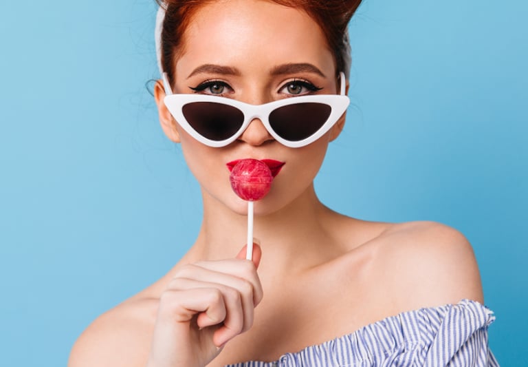 a woman with sunglasses and sunglasses on a blue background