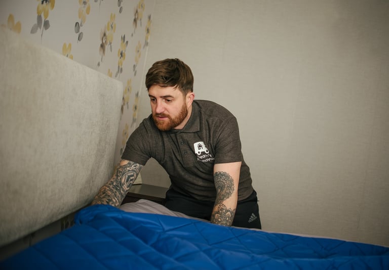 deanos removals worker covering a bed