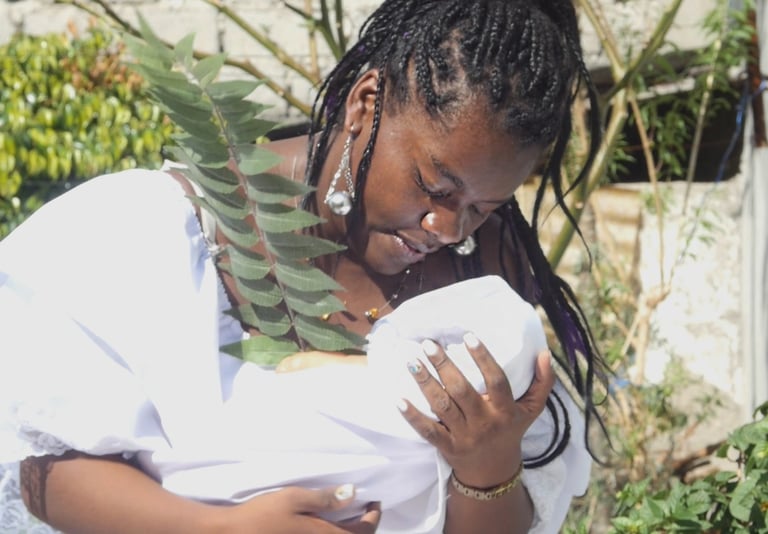 a woman holding a baby in her arms