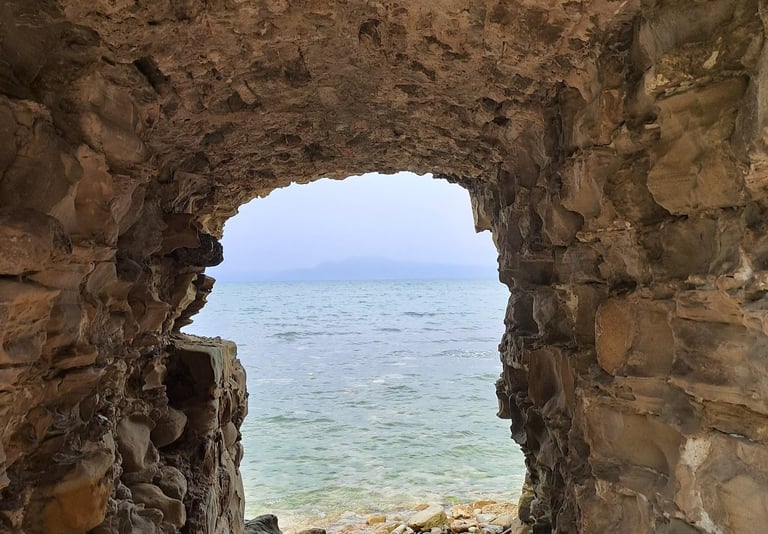 a stone archway leading to the ocean