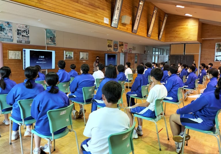 Student in hall watching a presentation.