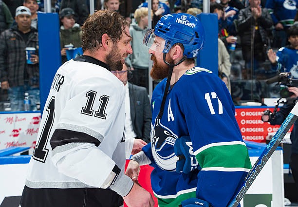 Filip Hronek of the Canucks congratulates Anze Kopitar of the Kings after his last NHL game in Vancouver, BC (Apr. 14/26)