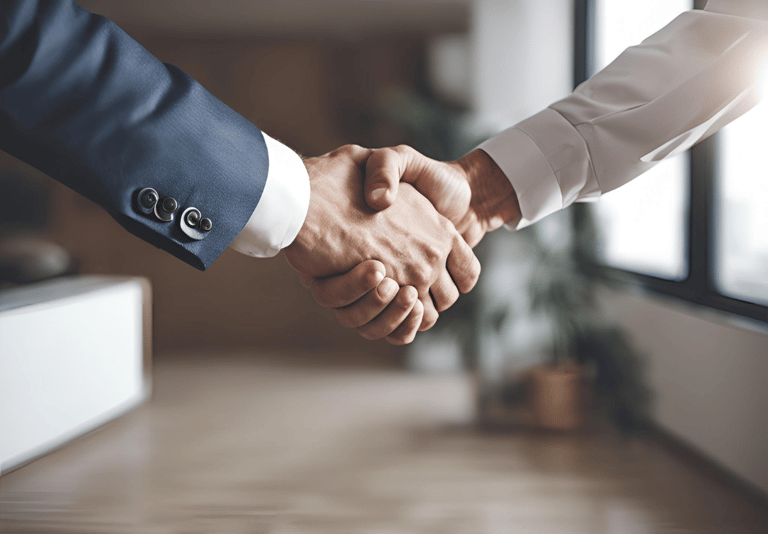 two people shaking hands in a room