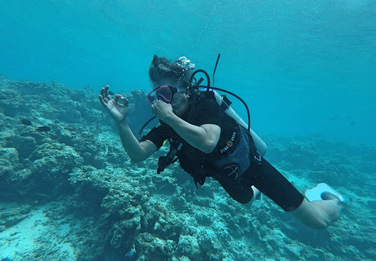 a man in a scuba suit is holding a camera and taking a picture of himself